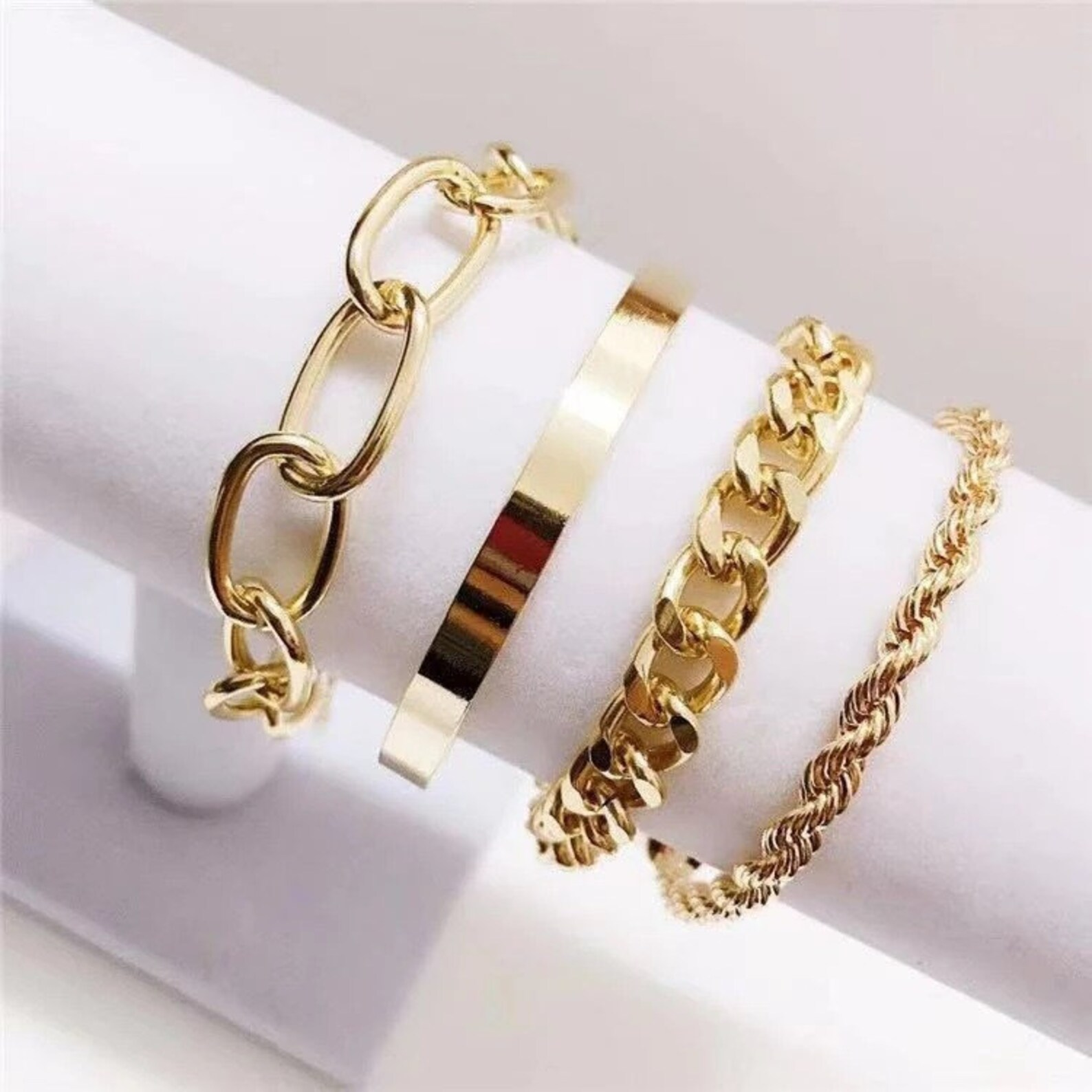 Twist Chain Exaggerated O-shaped Chain Cover Bracelet showcasing its geometric design in gold and white colors.