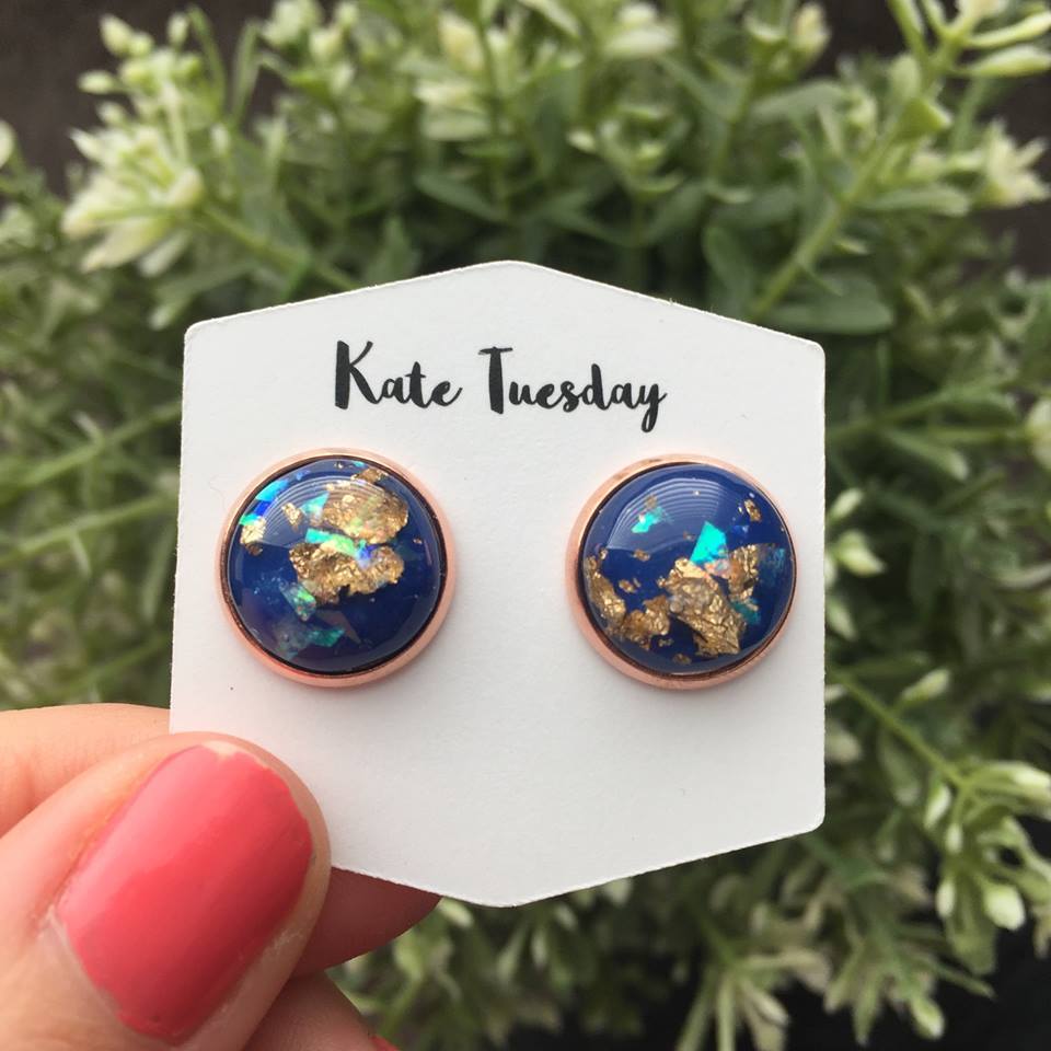 A pair of 12mm earrings featuring blue gold flakes set in a rose gold setting, showcasing elegance and style.