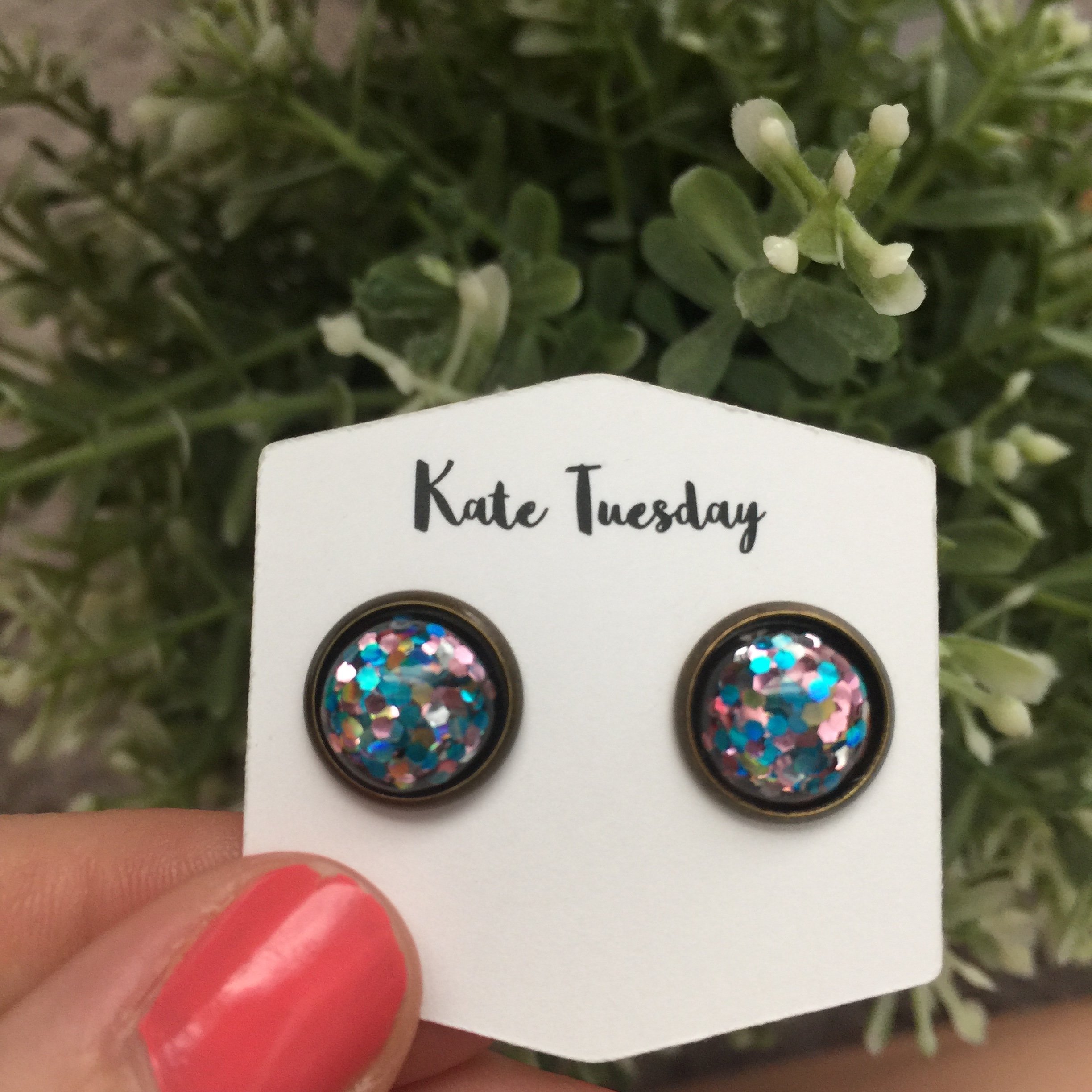 A pair of 12mm Pink Blue Glitter Earrings set in bronze, showcasing vibrant colors and sparkling glitter.