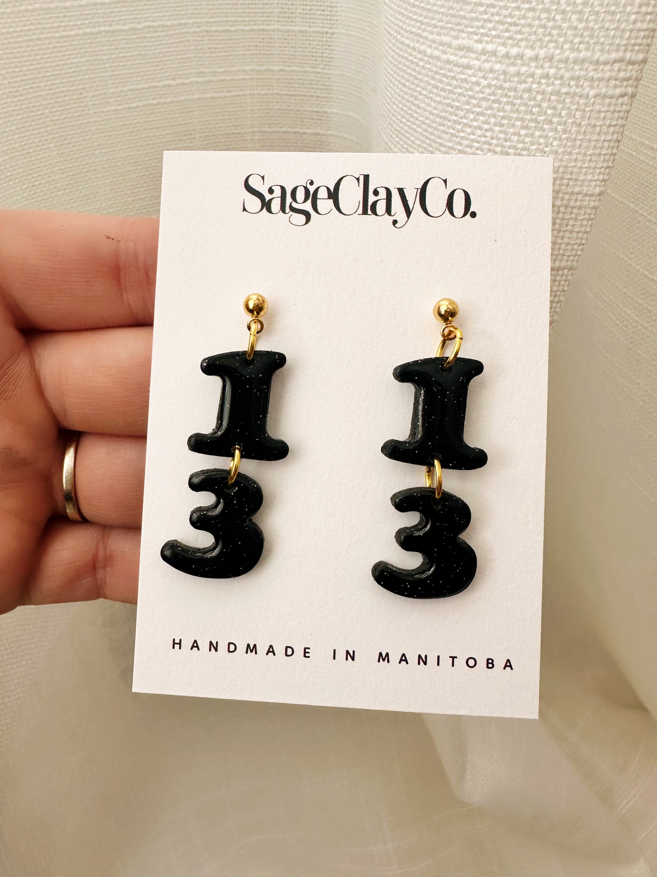 Handmade polymer clay earrings inspired by TS Reputation, featuring unique designs and lightweight hypoallergenic posts.