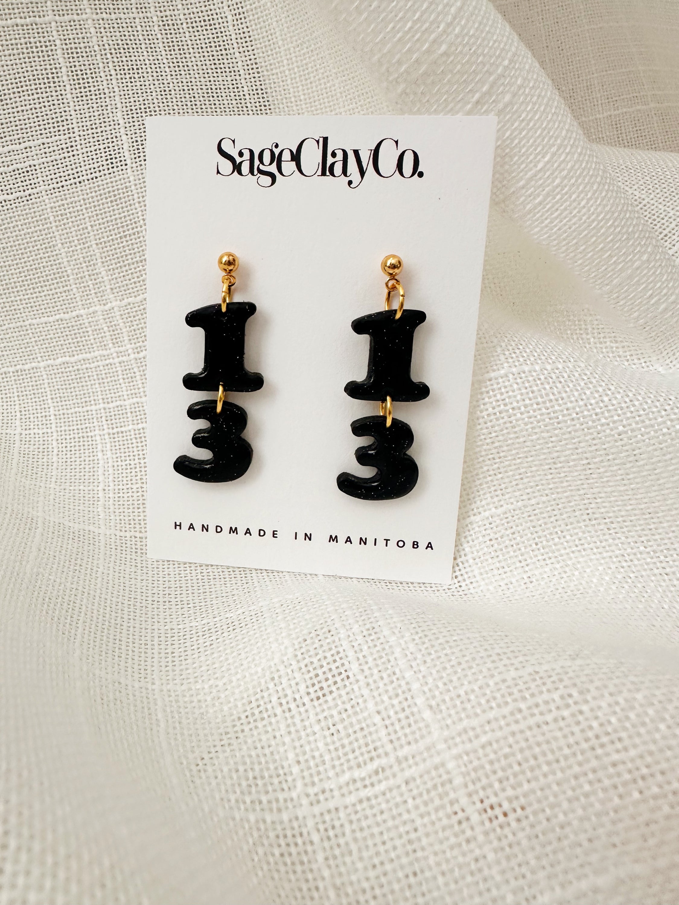 Handmade polymer clay earrings inspired by TS Reputation, featuring unique designs and lightweight hypoallergenic posts.