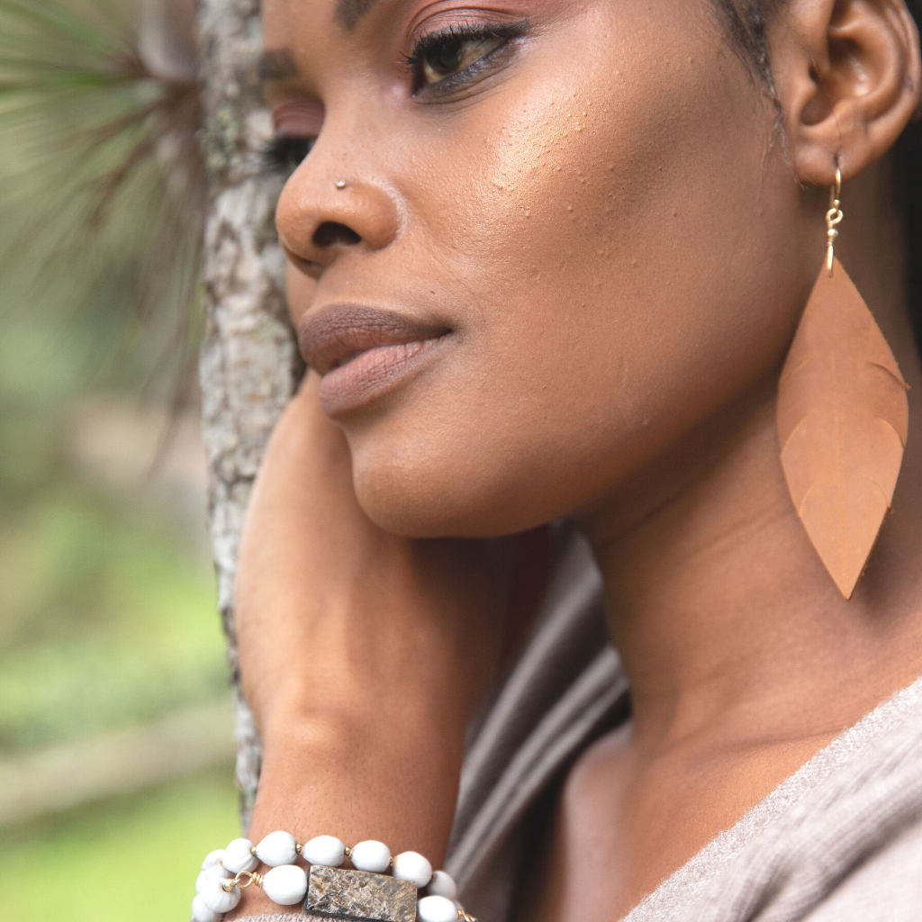 Elegant 14 Karat Gold Leather Feather Earrings with a lightweight design, handcrafted from genuine leather, featuring gold hooks.