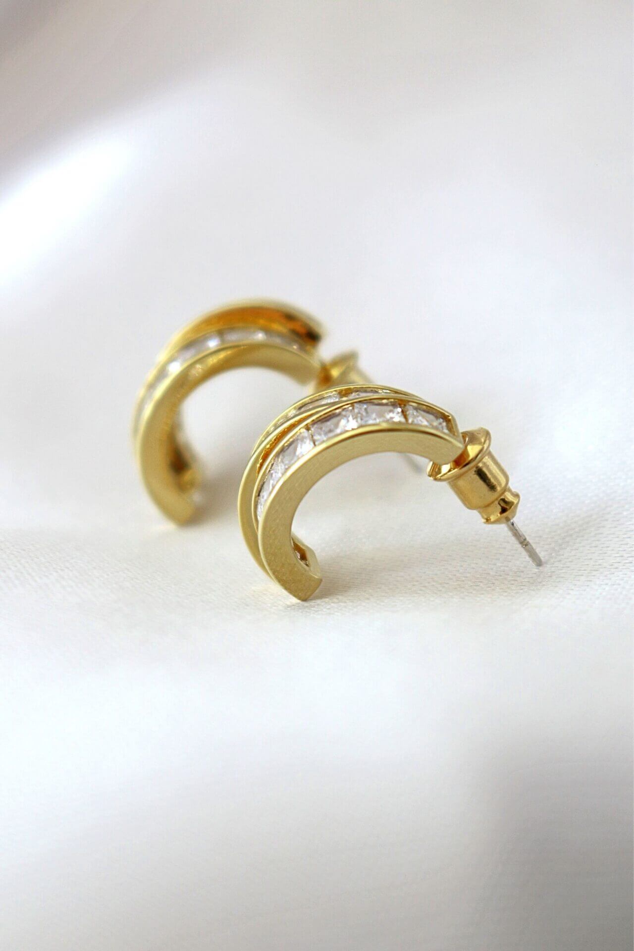 Gold hoop earrings with diamonds.