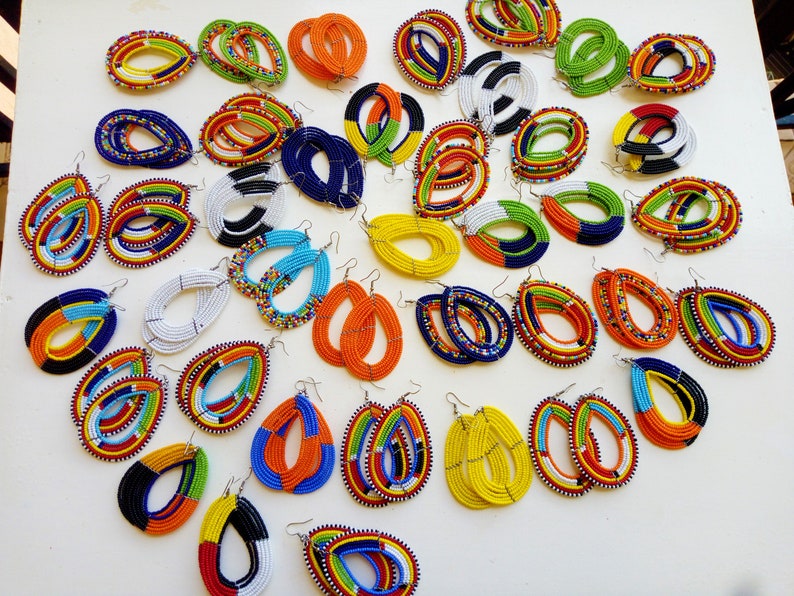 A vibrant collection of 40 pairs of African Maasai earrings, showcasing colorful glass beads and unique handcrafted designs.