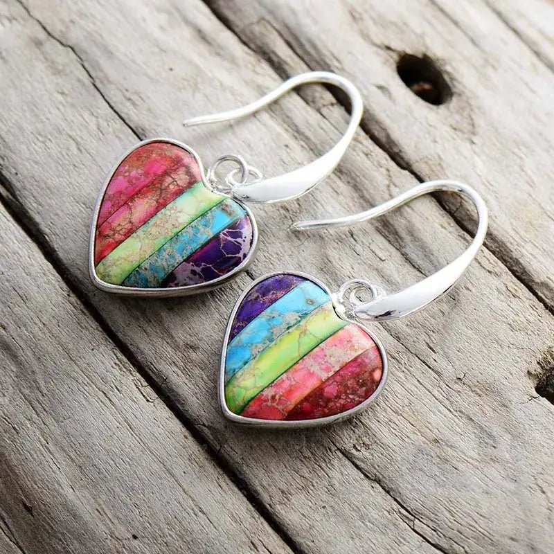 A pair of handcrafted 7 Chakra Heart Earrings made with natural Imperial Jasper stones, showcasing vibrant colors and a bohemian design.