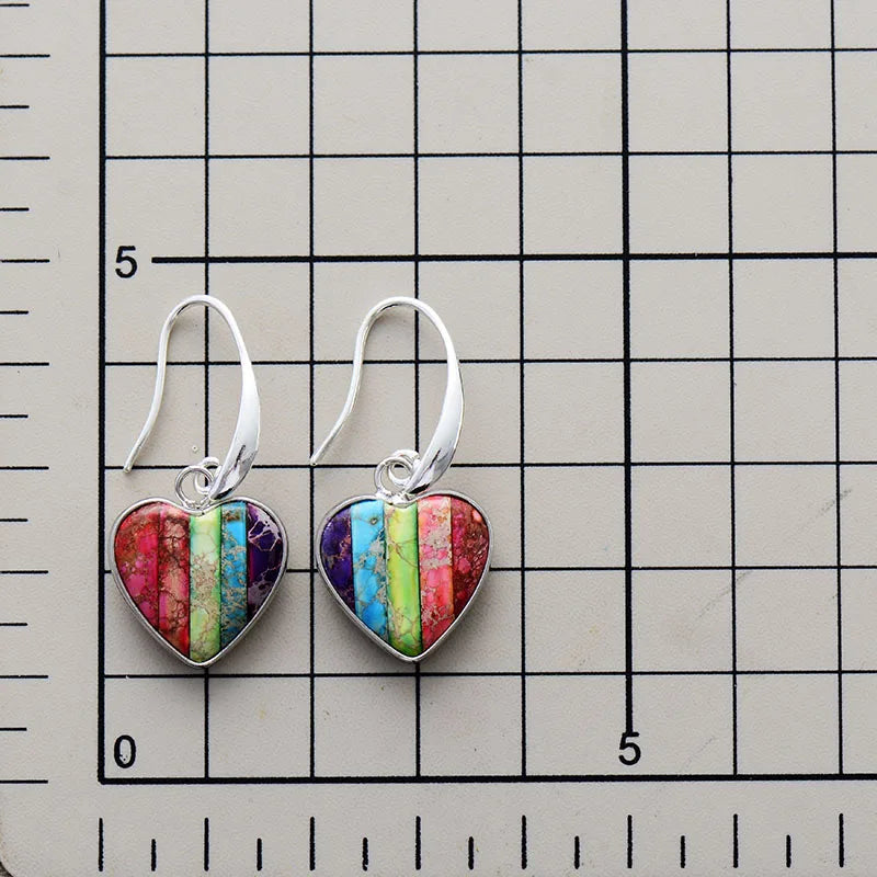 A pair of handcrafted 7 Chakra Heart Earrings made with natural Imperial Jasper stones, showcasing vibrant colors and a bohemian design.