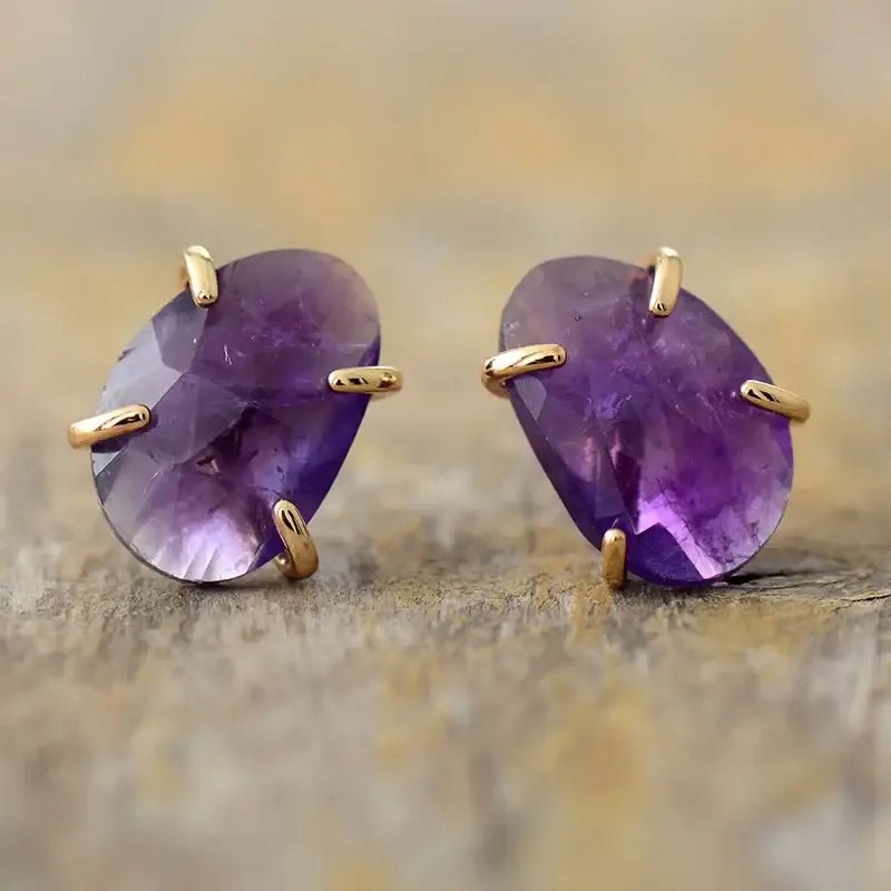 A pair of handmade Amethyst Stud Earrings featuring natural purple amethyst stones set in a stylish design, perfect for any occasion.