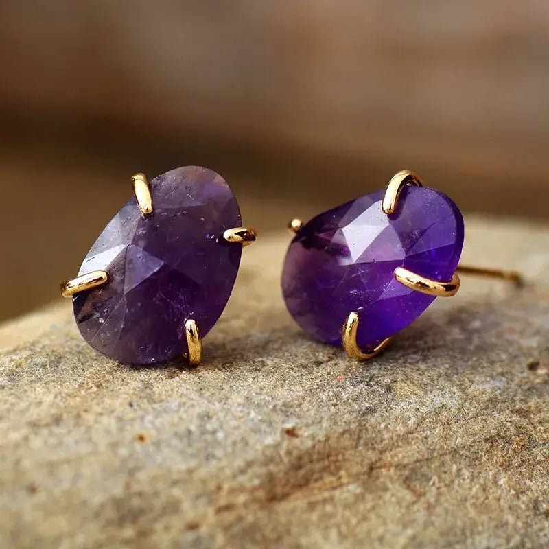 A pair of handmade Amethyst Stud Earrings featuring natural purple amethyst stones set in a stylish design, perfect for any occasion.