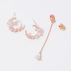 Asymmetric Sparkle Earrings featuring silver and rose gold plating with genuine crystals, showcasing a unique design with one stud and one dangling earring.