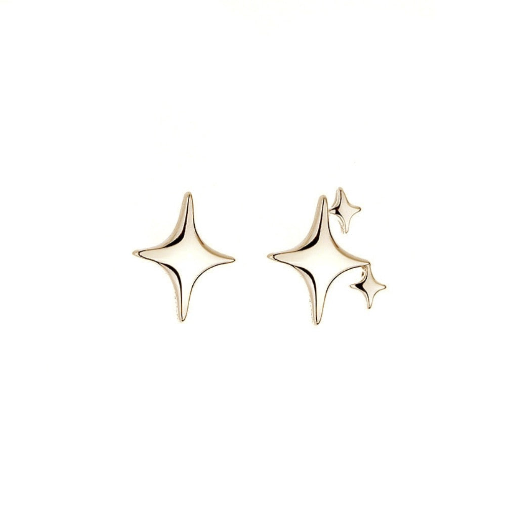 A pair of Asymmetrical Star Stud Earrings in gold and silver, showcasing a modern design with a smooth finish.