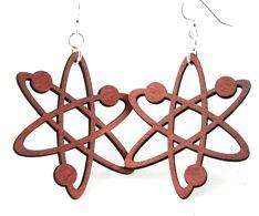 A pair of cherry red Atom Earrings, laser-cut from sustainable wood, featuring silver-finished hypoallergenic ear wires.