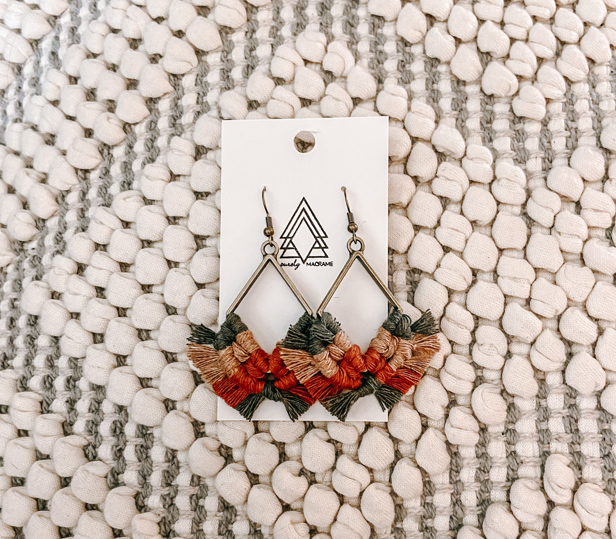 A pair of lightweight Autumn Diamonds earrings made from 100% macrame cotton, featuring a unique diamond pattern and lead-free, nickel-free metals.