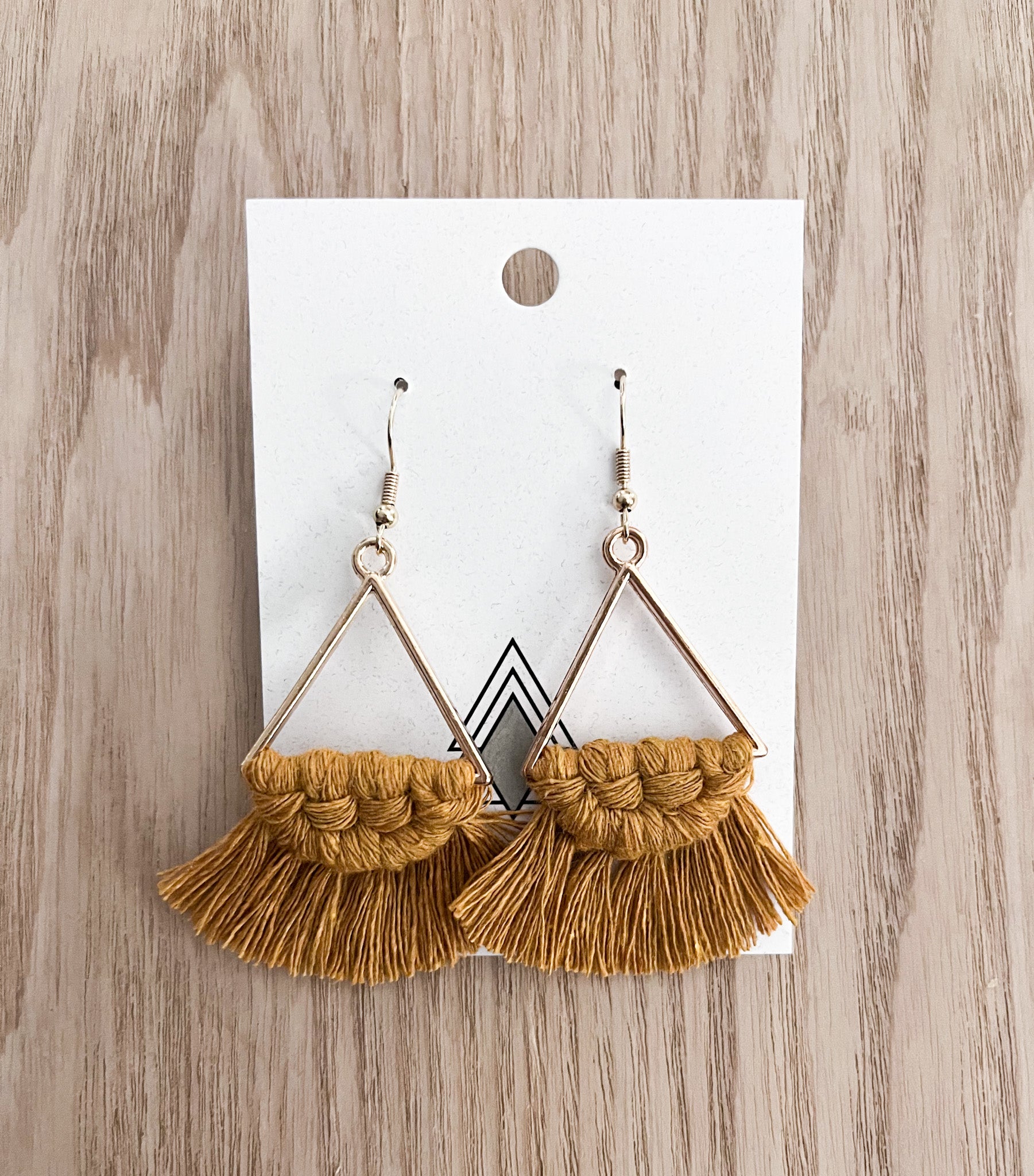 A pair of Autumn Mustard Triangles made from 100% cotton cord, showcasing a vibrant yellow color and lightweight design.