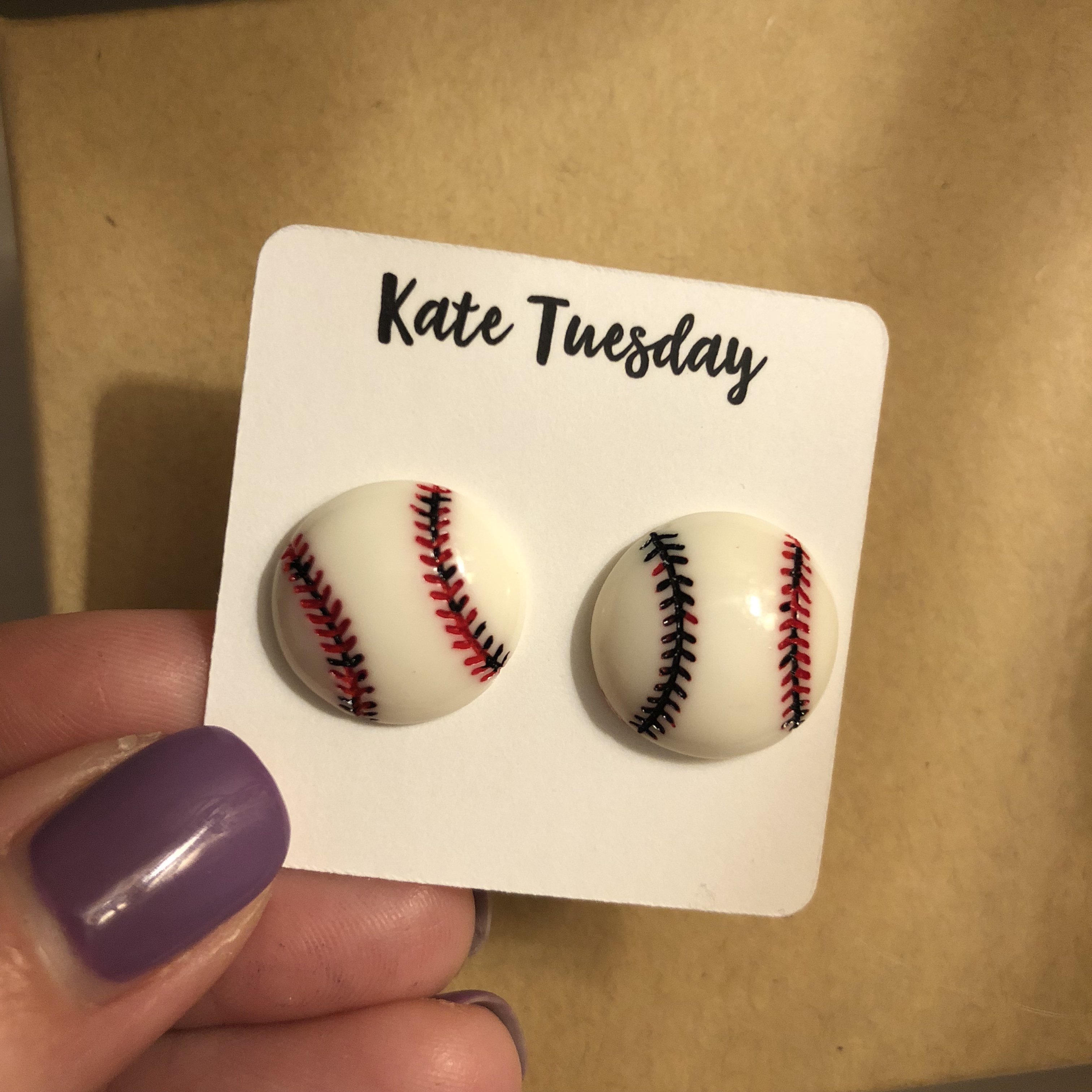 A pair of Baseball Stud Earrings in 14mm and 10mm sizes, showcasing a baseball design with a shiny finish.