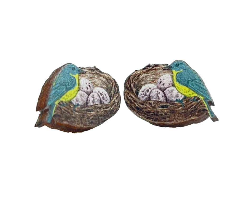 A pair of Bird Nest Stud Earrings made from sustainably sourced wood, featuring a laser-cut design with a natural wood back and silver-finished stainless steel ear wires.