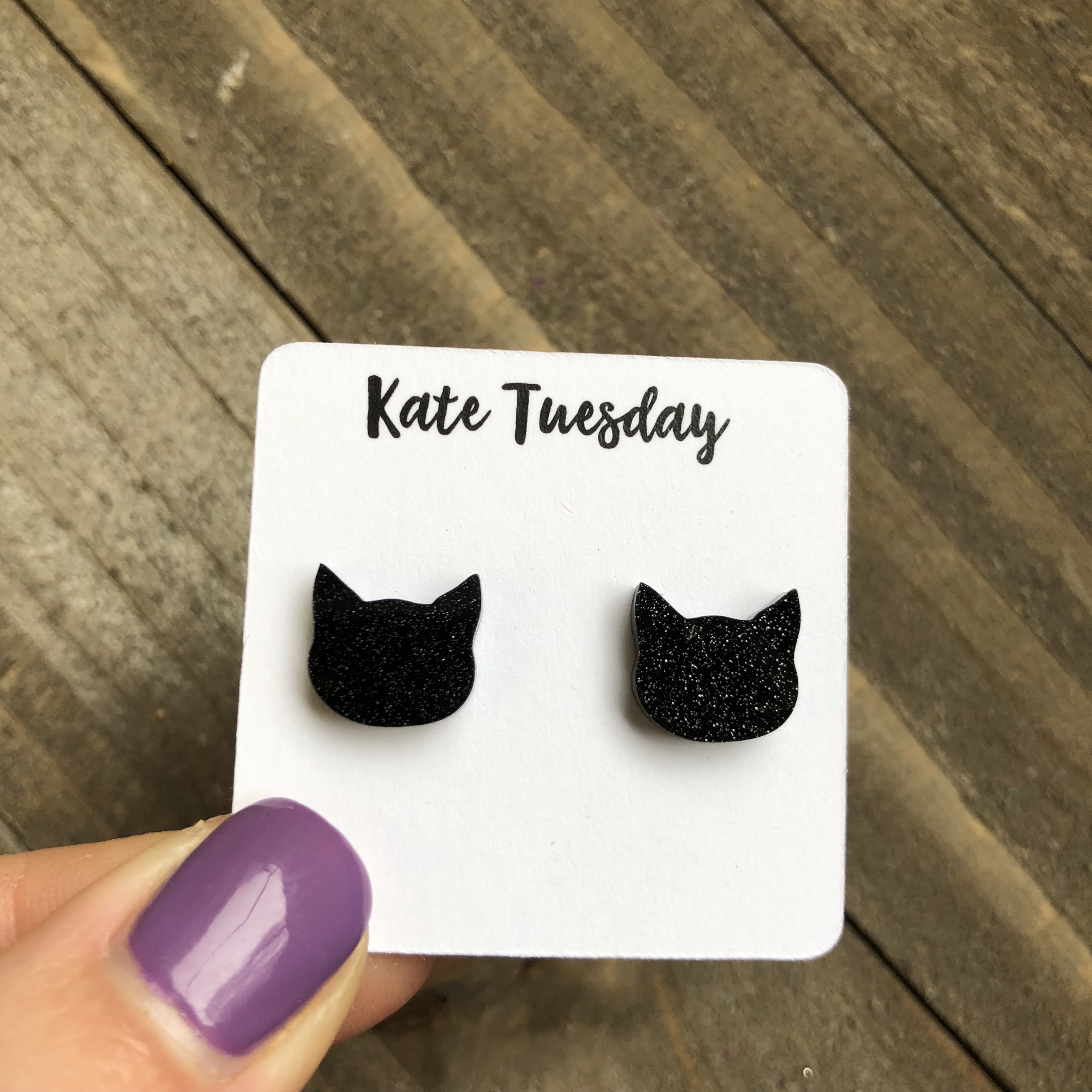 Black glittery acrylic cat earrings with a stylish design, perfect for cat lovers.