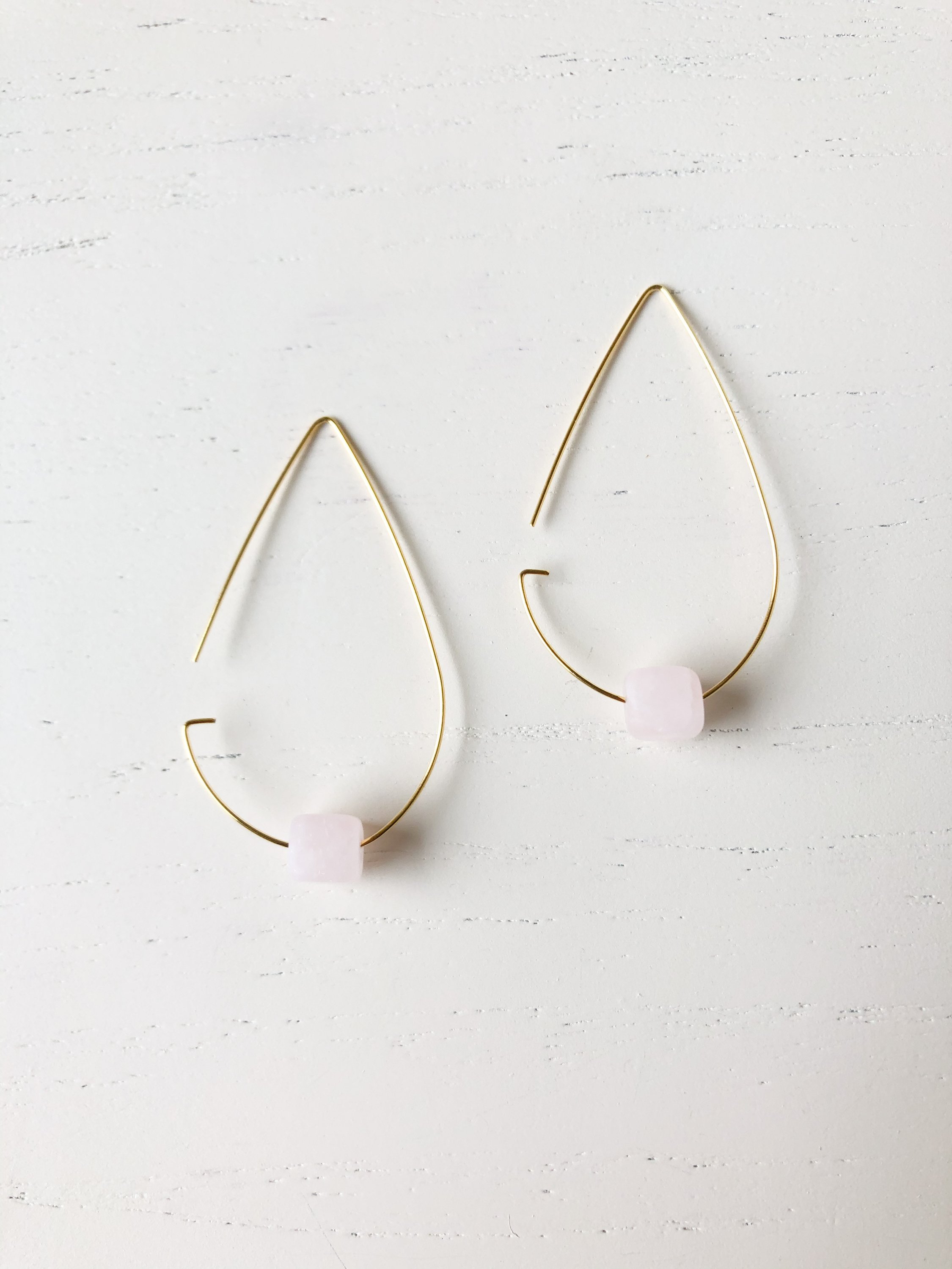 Elegant brass tear drop threader earrings with rose quartz stones, measuring 1 3/4 inches long.