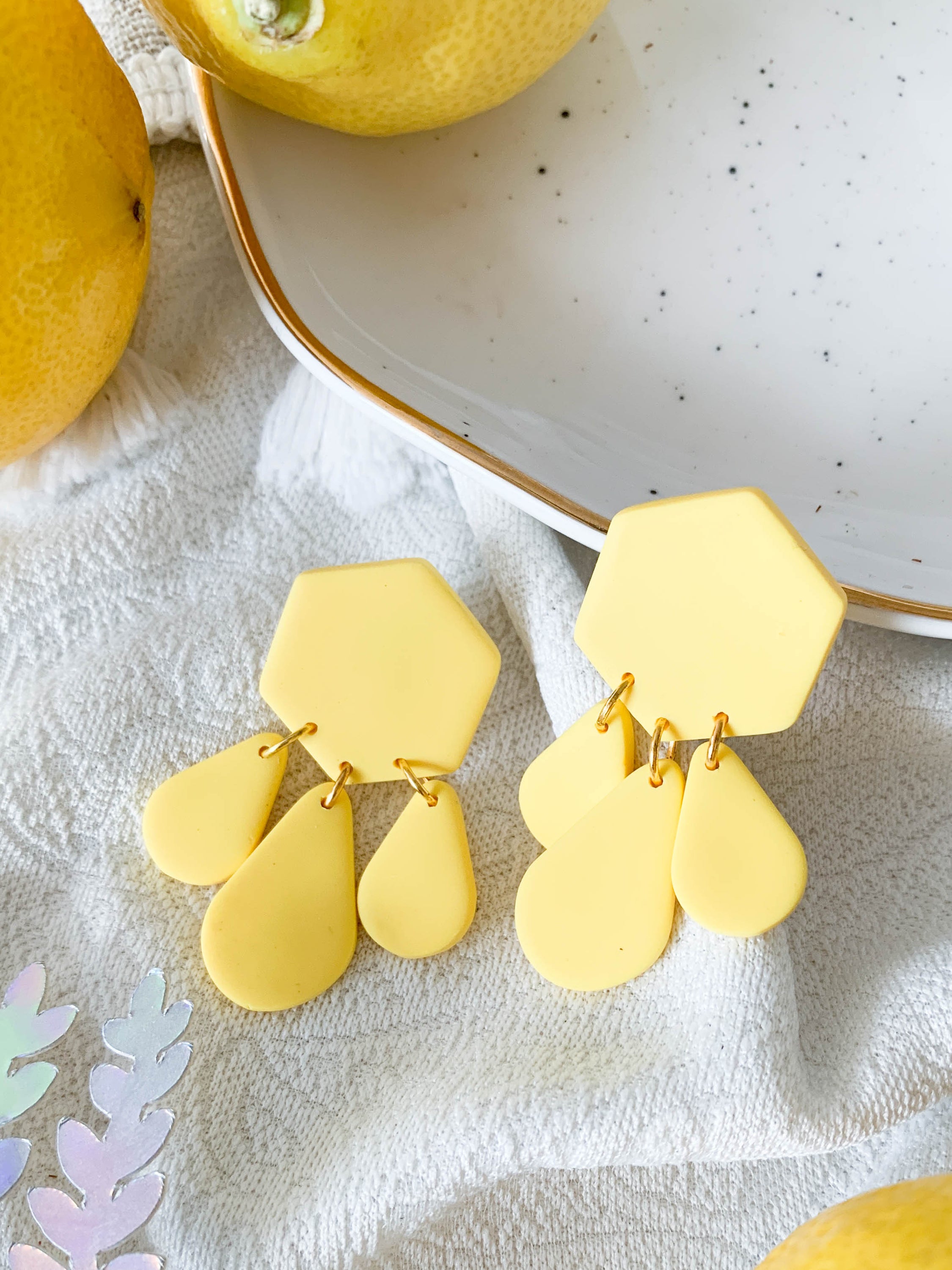 Bridget Lemon earrings featuring a hexagon teardrop design in vibrant yellow, perfect for adding a cheerful touch to any outfit.