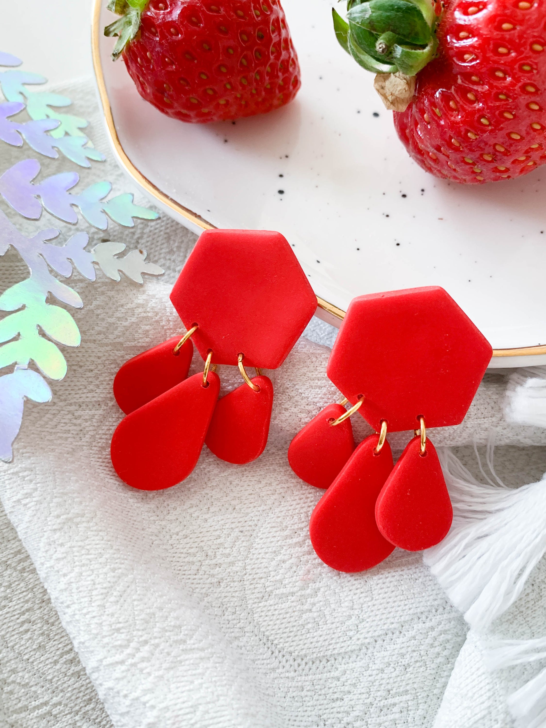 Bridget Strawberry geometric hexagon teardrop dangle earrings in vibrant red and green colors, showcasing a modern design.