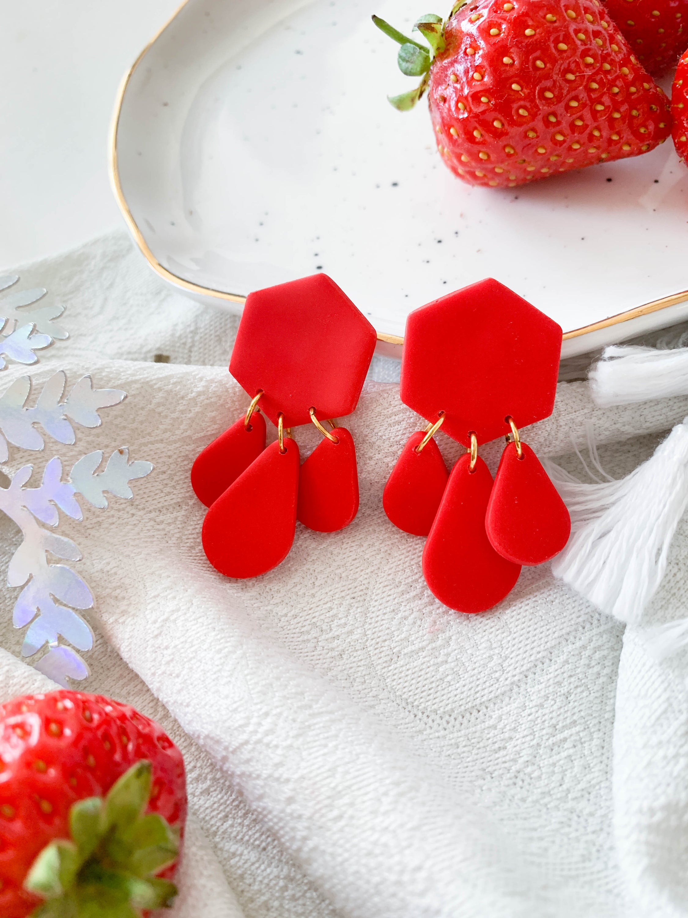 Bridget Strawberry geometric hexagon teardrop dangle earrings in vibrant red and green colors, showcasing a modern design.