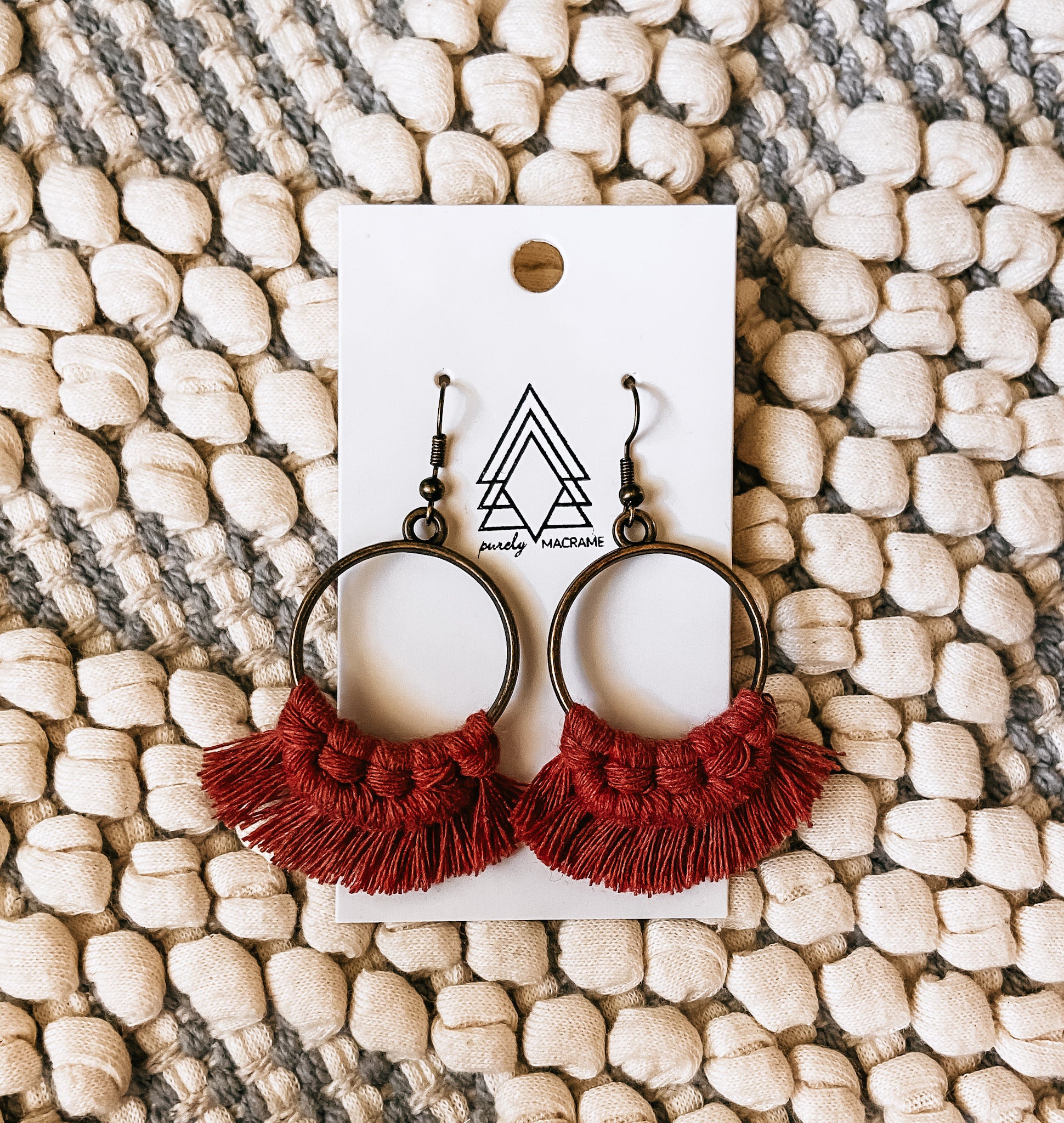 A pair of stylish Cinnamon Round Earrings made from 100% macrame cotton, featuring a unique round design in a warm cinnamon color.