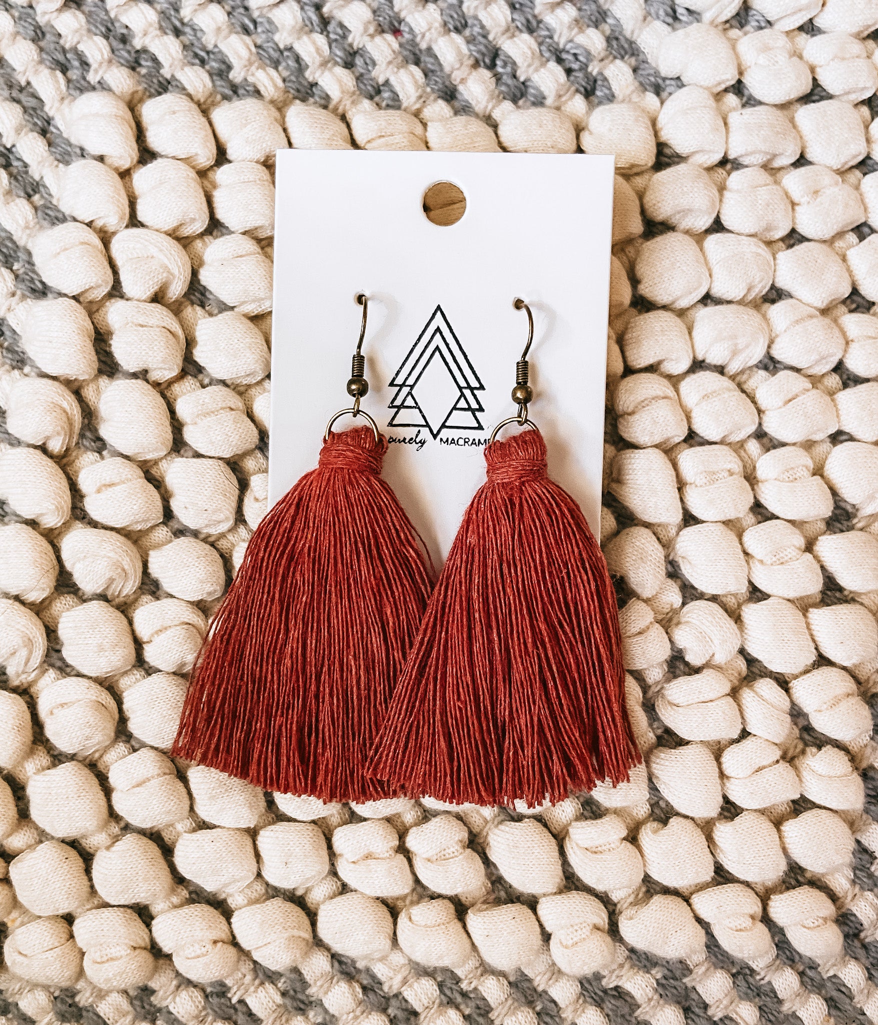 A pair of stylish Cinnamon Tassel Earrings made from 100% macrame cotton, featuring a lightweight and hypoallergenic design.