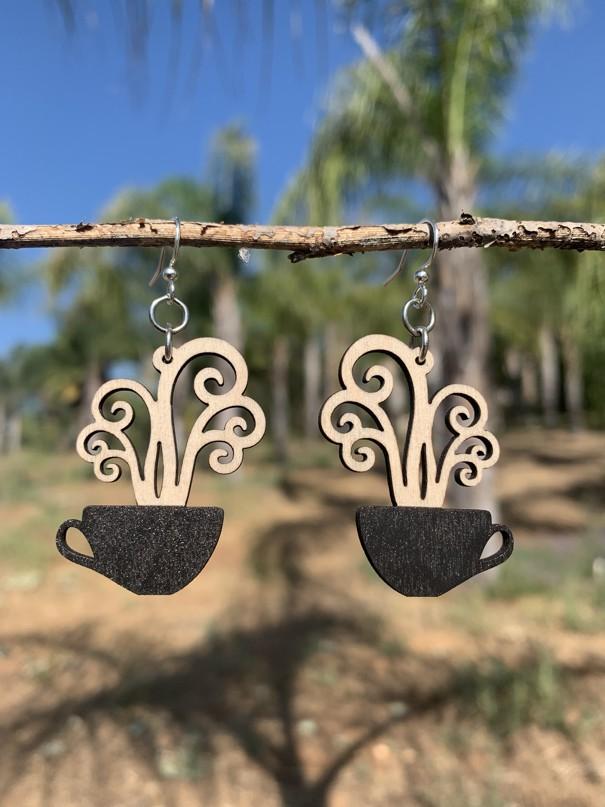 A pair of stylish coffee cup earrings made from sustainably sourced wood, featuring silver-finished stainless steel ear wires.