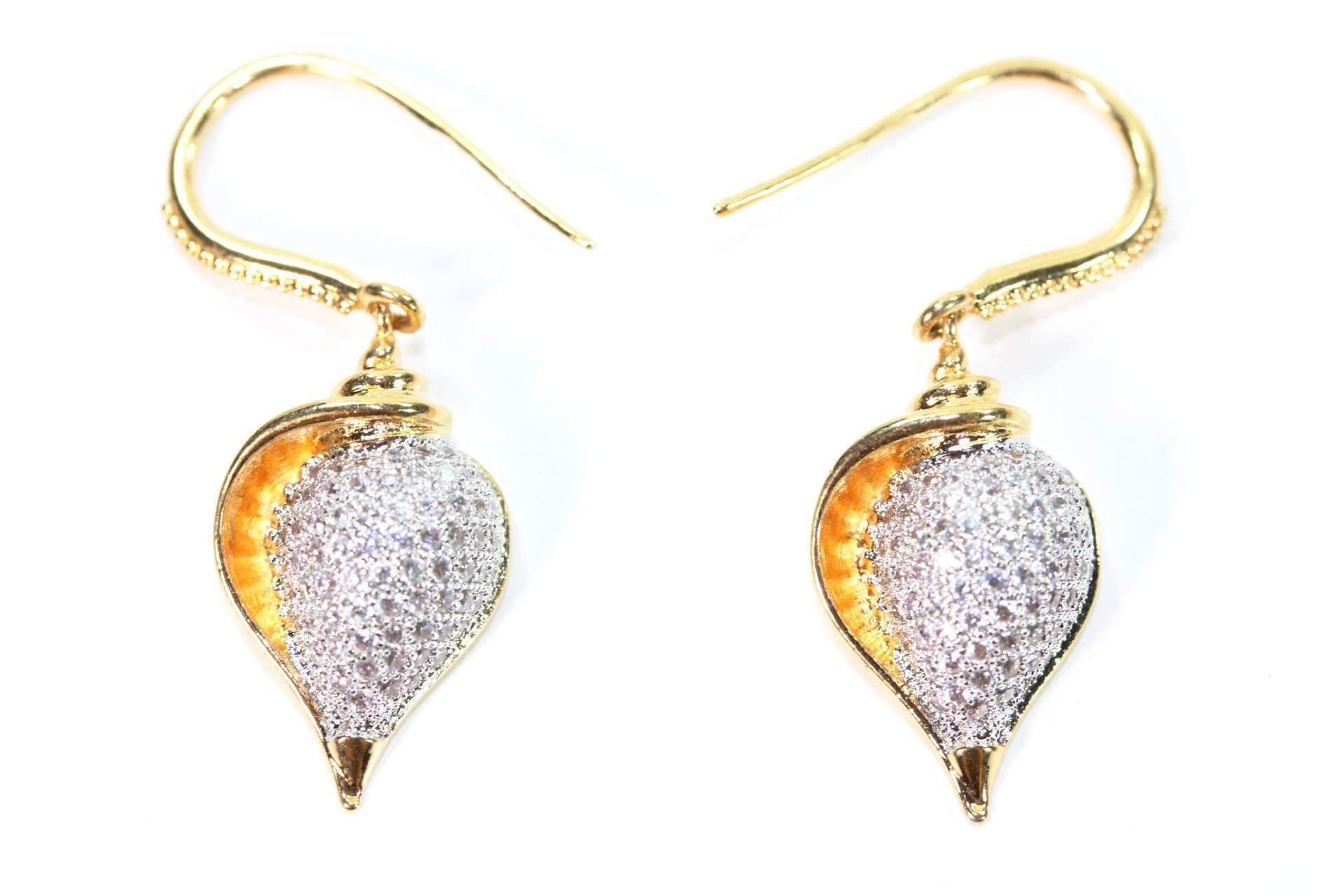 A pair of elegant conch shell earrings featuring pave cubic zirconia and gold tone hooks, showcasing a unique and stylish design.