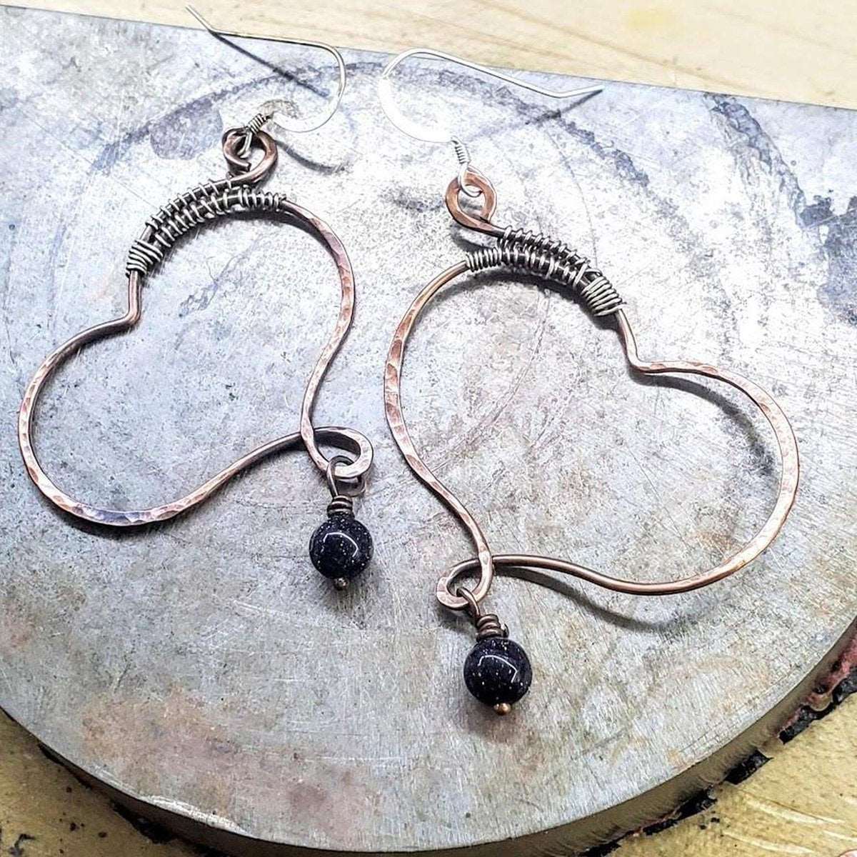 Handmade Copper Butterfly Wing Earrings symbolizing child abuse survivors, featuring blue-black sandstone charm and sterling silver accents.