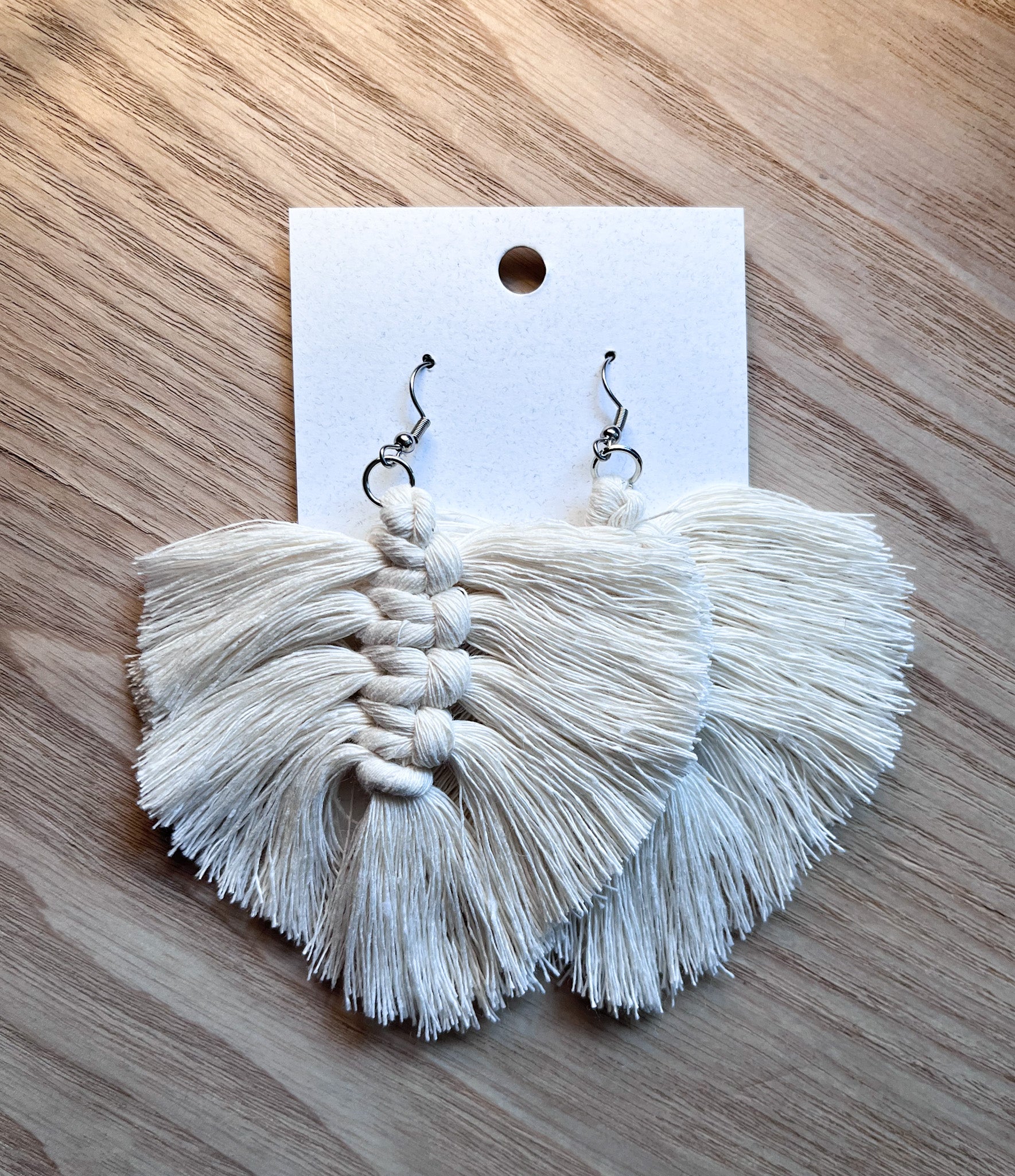 Elegant cream-colored macrame cotton feathers, lightweight and stylish, perfect for accessories.