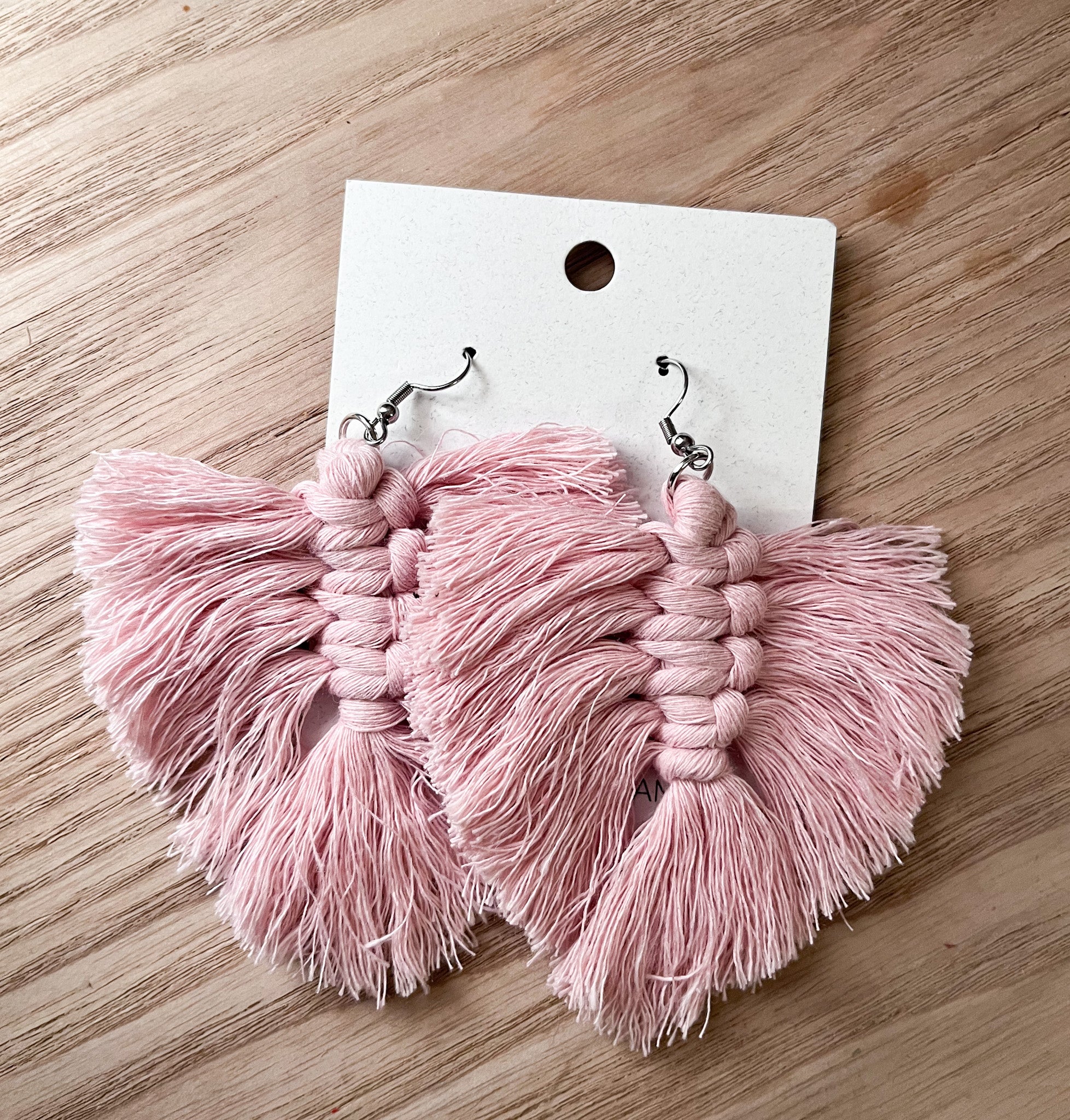 Elegant cream-colored macrame cotton feathers, lightweight and stylish, perfect for accessories.