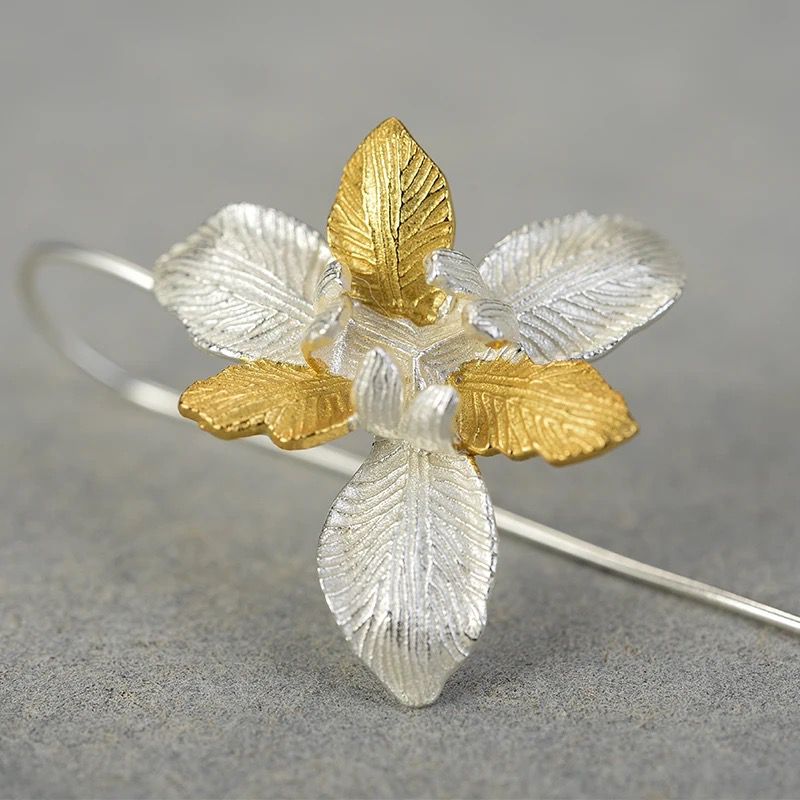 A pair of Daffodil Earrings featuring a delicate flower design, crafted from 925 sterling silver and 18K gold plating, showcasing elegance and sophistication.