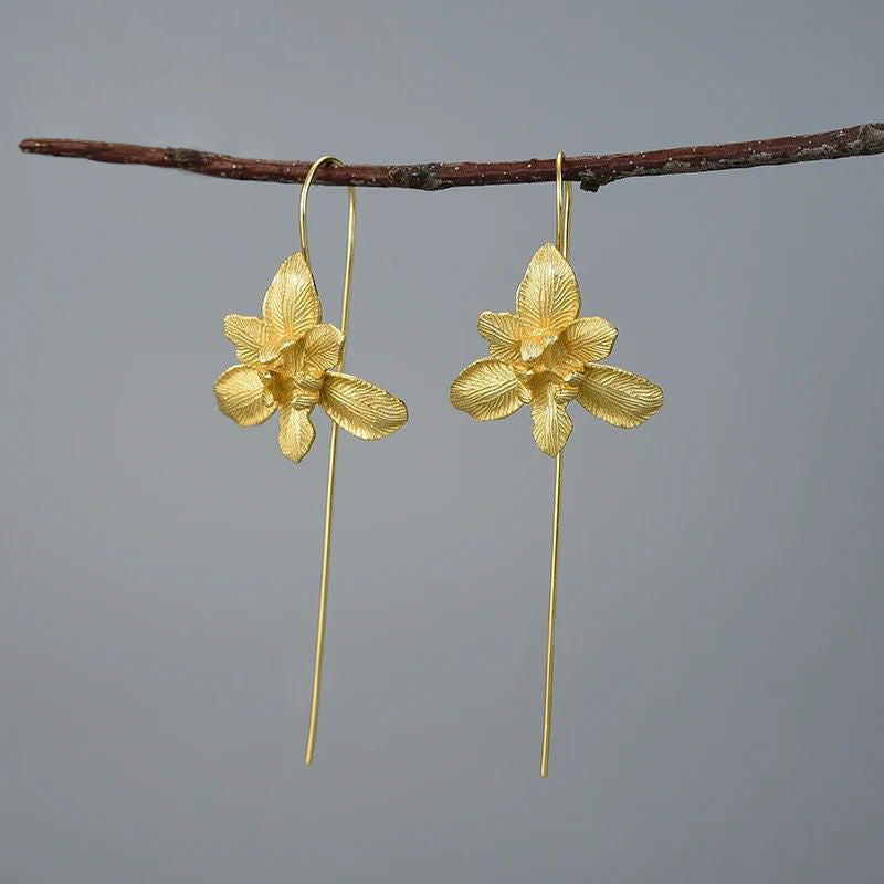 A pair of Daffodil Earrings featuring a delicate flower design, crafted from 925 sterling silver and 18K gold plating, showcasing elegance and sophistication.