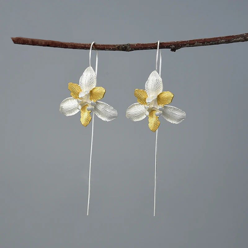 A pair of Daffodil Earrings featuring a delicate flower design, crafted from 925 sterling silver and 18K gold plating, showcasing elegance and sophistication.