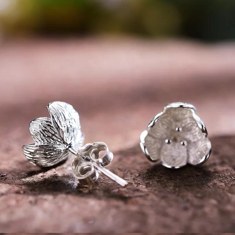 Dainty Blooms stud earrings featuring floral design in sterling silver with warm 18K gold plating, perfect for everyday elegance.