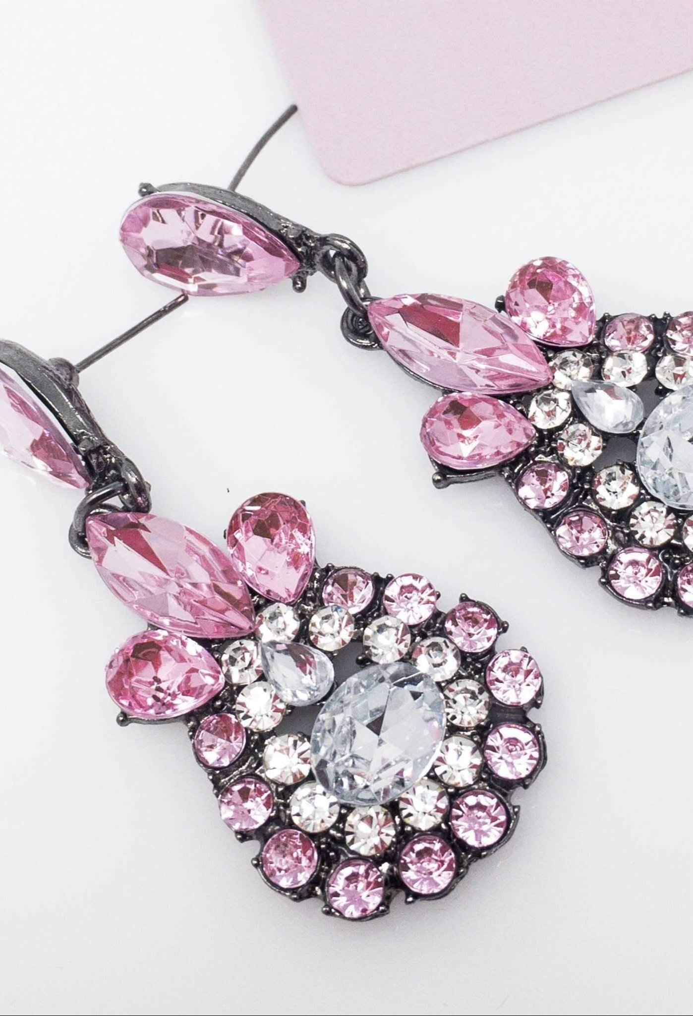 Dangle - Charisma Earrings featuring sparkling rhinestones in a teardrop design, available in pink and blue colors.