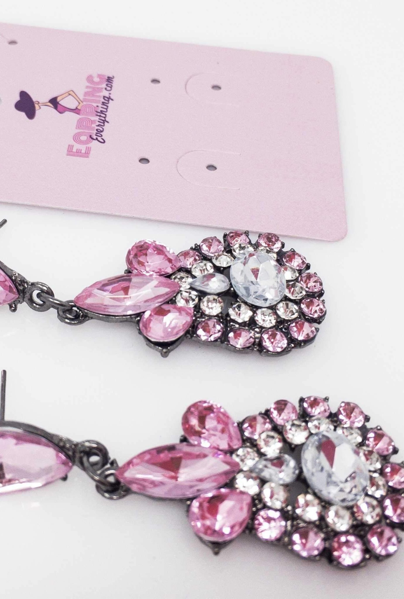 Dangle - Charisma Earrings featuring sparkling rhinestones in a teardrop design, available in pink and blue colors.