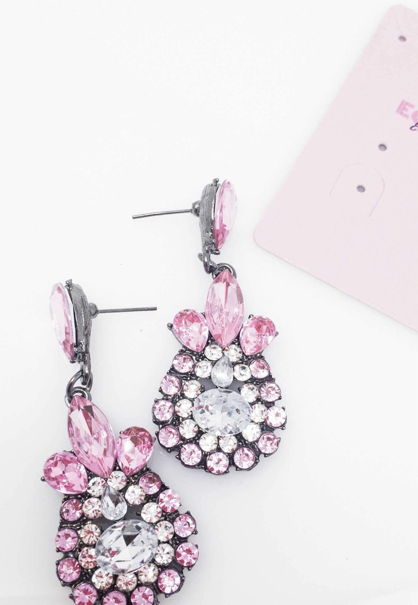 Dangle - Charisma Earrings featuring sparkling rhinestones in a teardrop design, available in pink and blue colors.