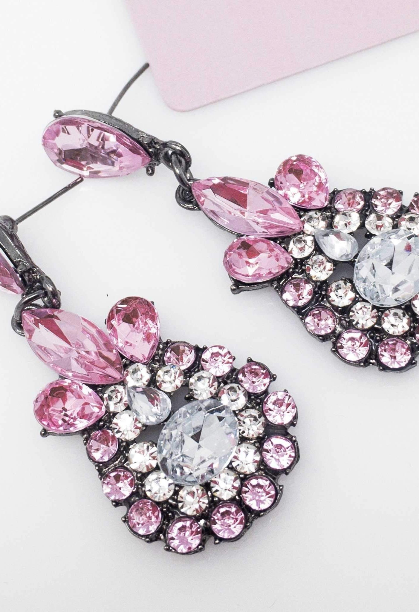 Dangle - Charisma Earrings featuring sparkling rhinestones in a teardrop design, available in pink and blue colors.