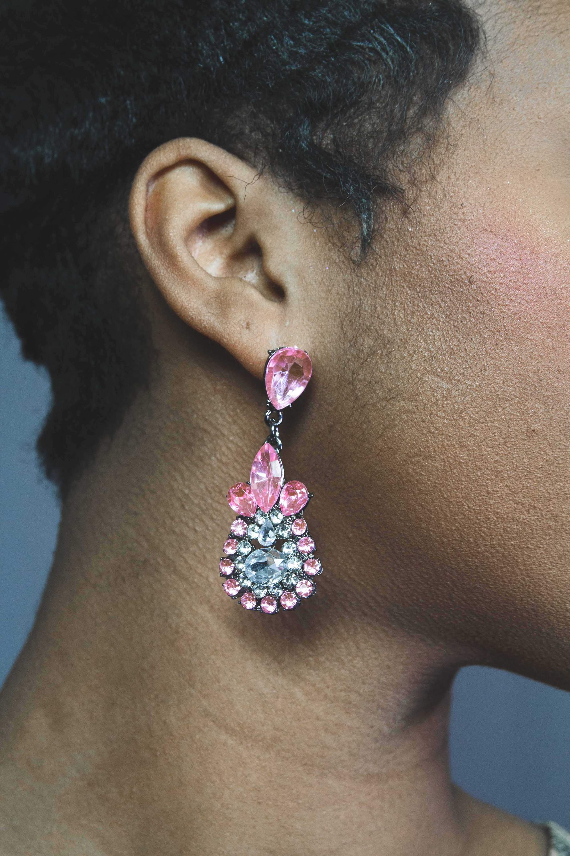 Dangle - Charisma Earrings featuring sparkling rhinestones in a teardrop design, available in pink and blue colors.