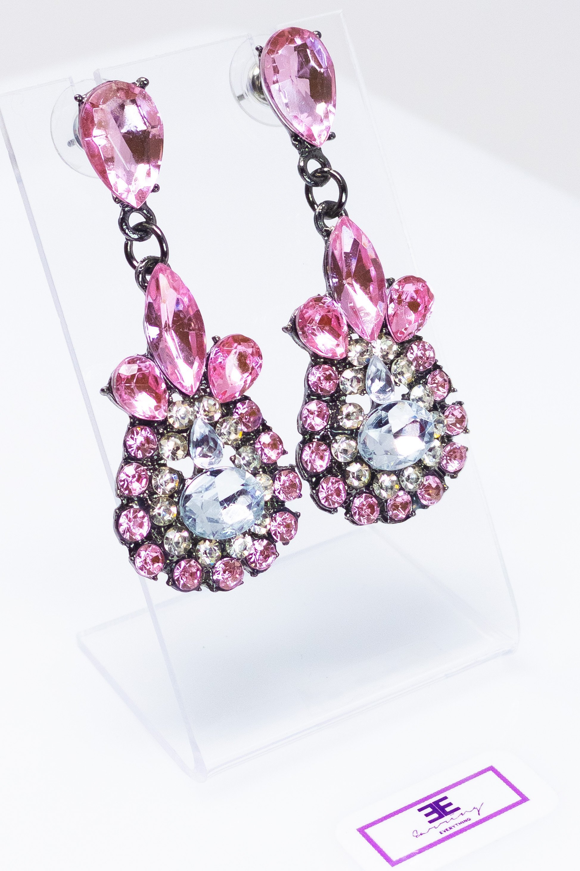 Dangle - Charisma Earrings featuring sparkling rhinestones in a teardrop design, available in pink and blue colors.