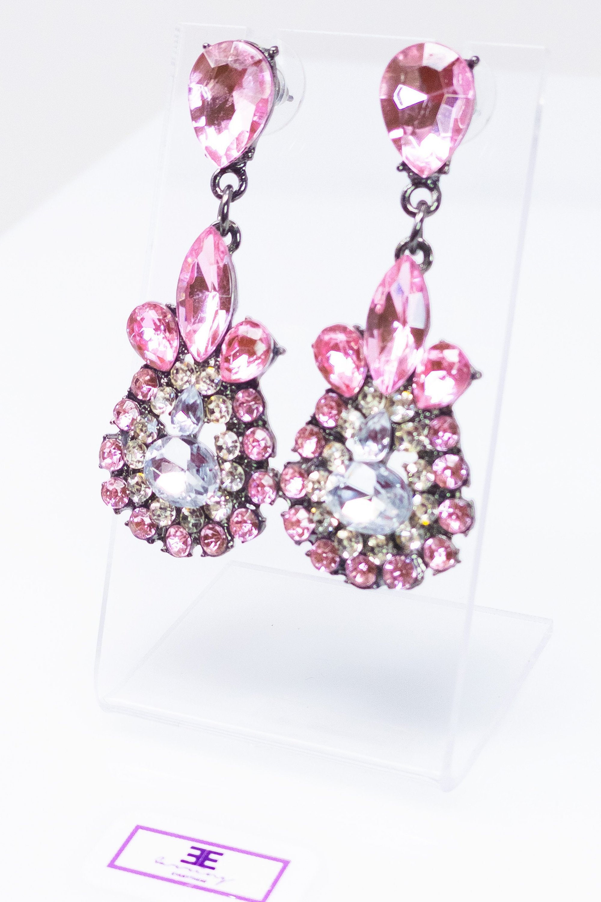 Dangle - Charisma Earrings featuring sparkling rhinestones in a teardrop design, available in pink and blue colors.