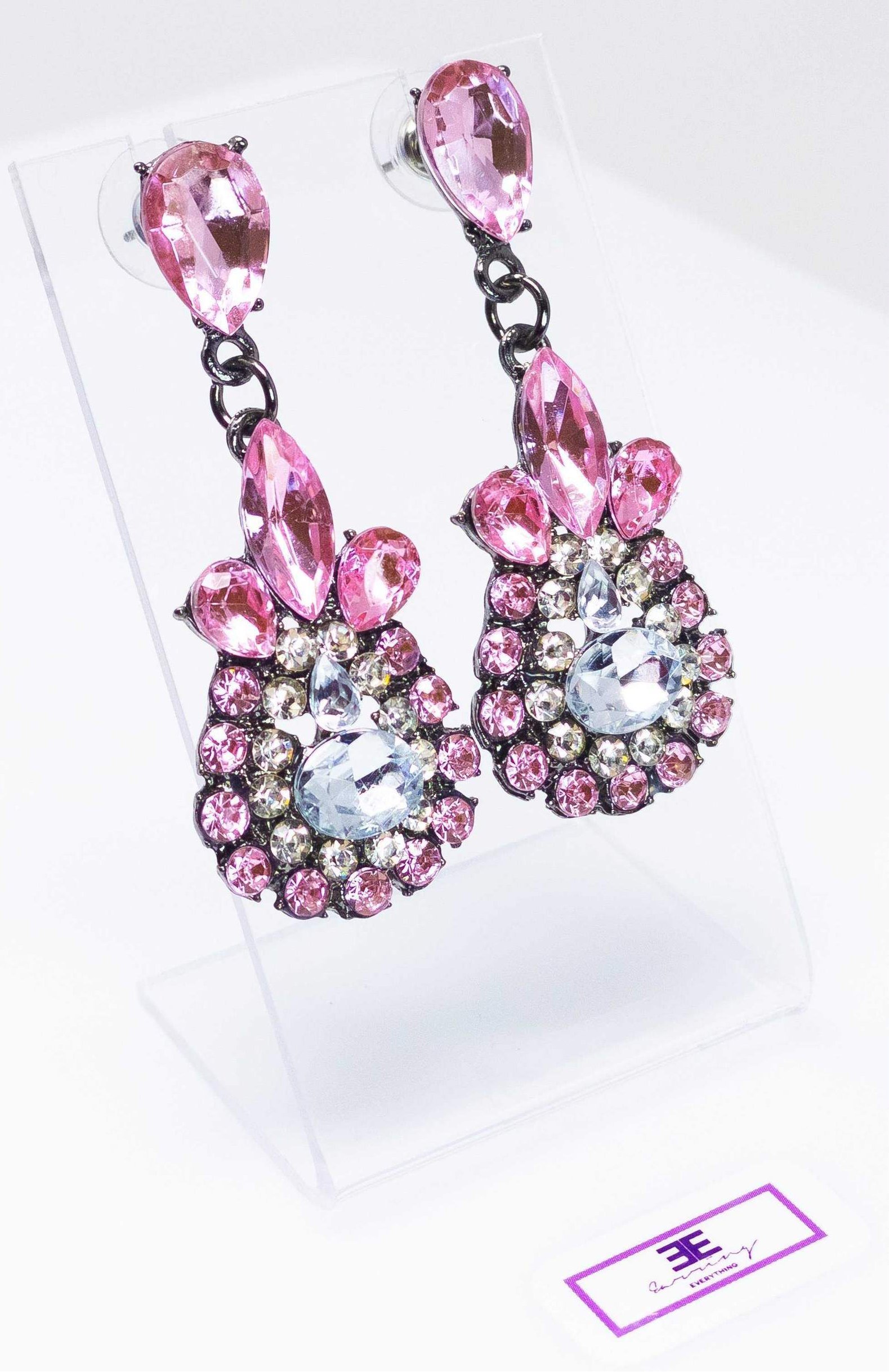 Dangle - Charisma Earrings featuring sparkling rhinestones in a teardrop design, available in pink and blue colors.