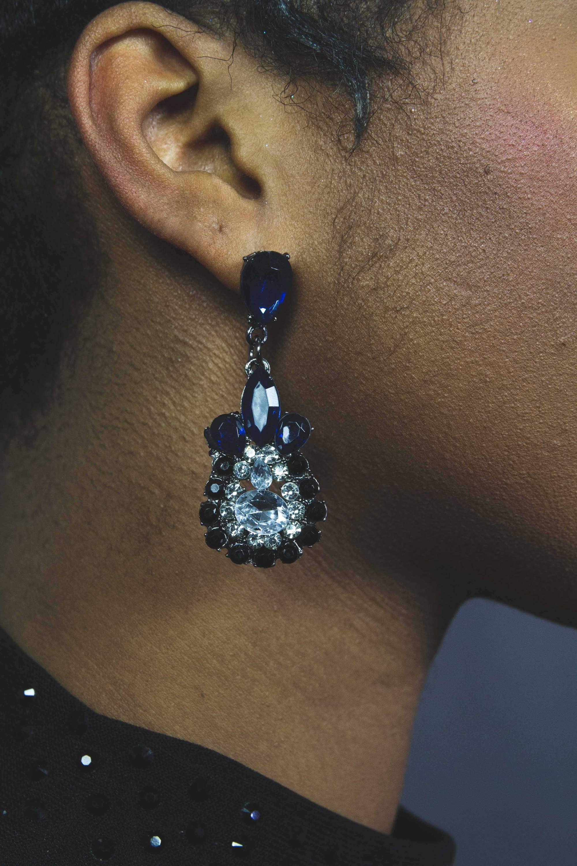 Dangle - Charisma Earrings featuring sparkling rhinestones in a teardrop design, available in pink and blue colors.