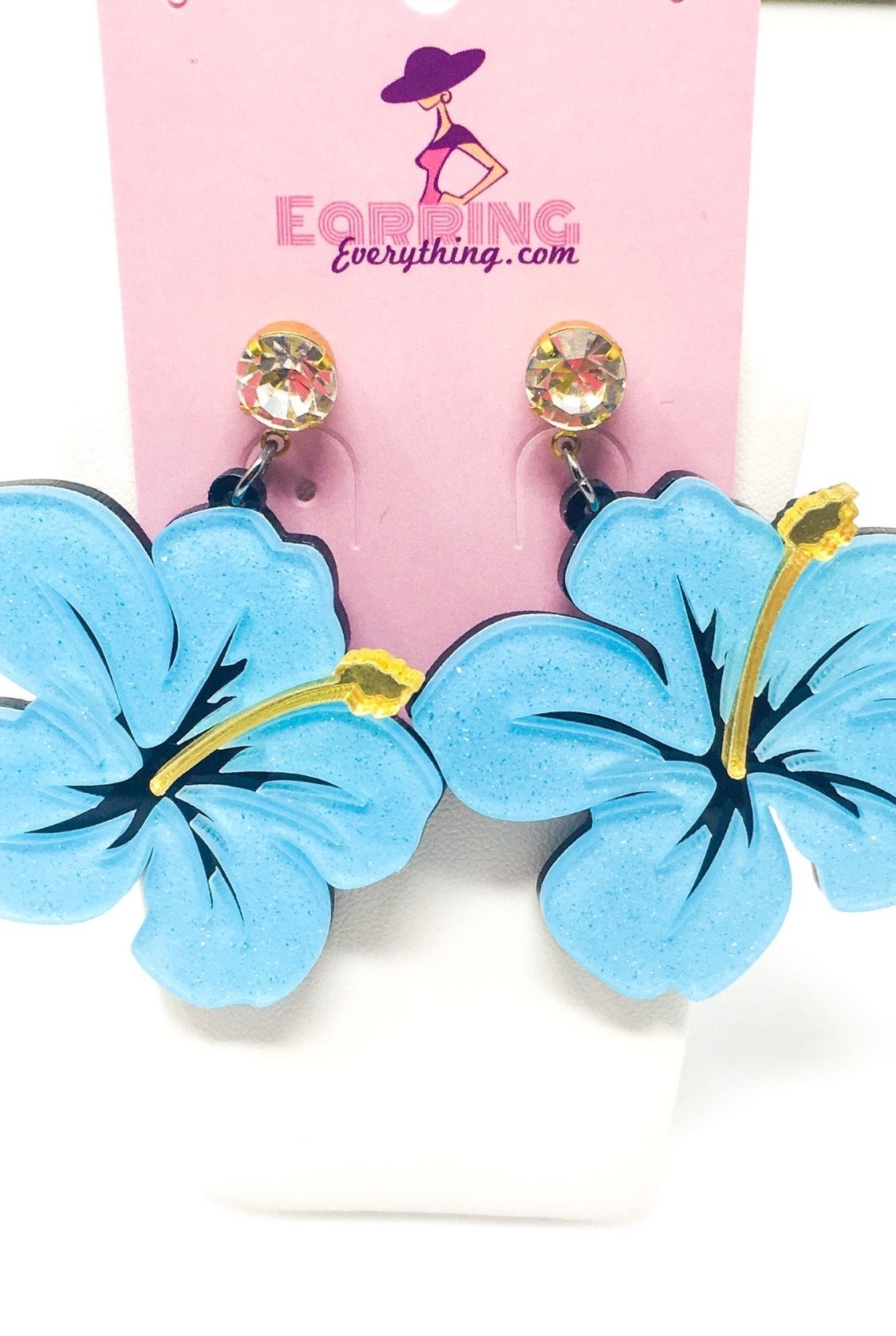 Dangle Hawaiian Hibiscus earrings featuring pink and blue acrylic sparkle drop design in a geometric heart shape.