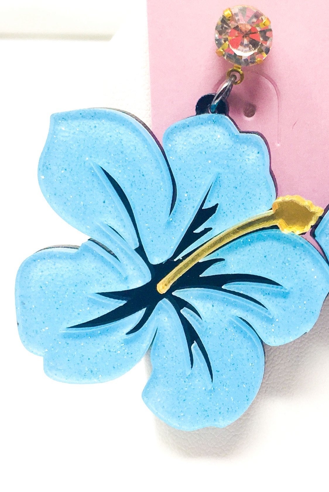 Dangle Hawaiian Hibiscus earrings featuring pink and blue acrylic sparkle drop design in a geometric heart shape.