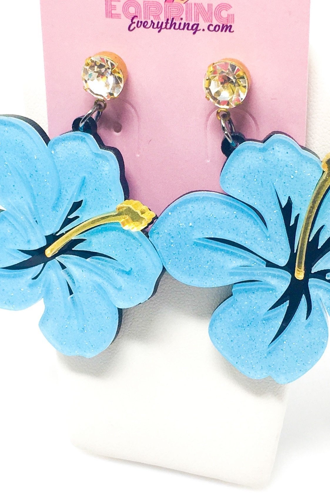 Dangle Hawaiian Hibiscus earrings featuring pink and blue acrylic sparkle drop design in a geometric heart shape.