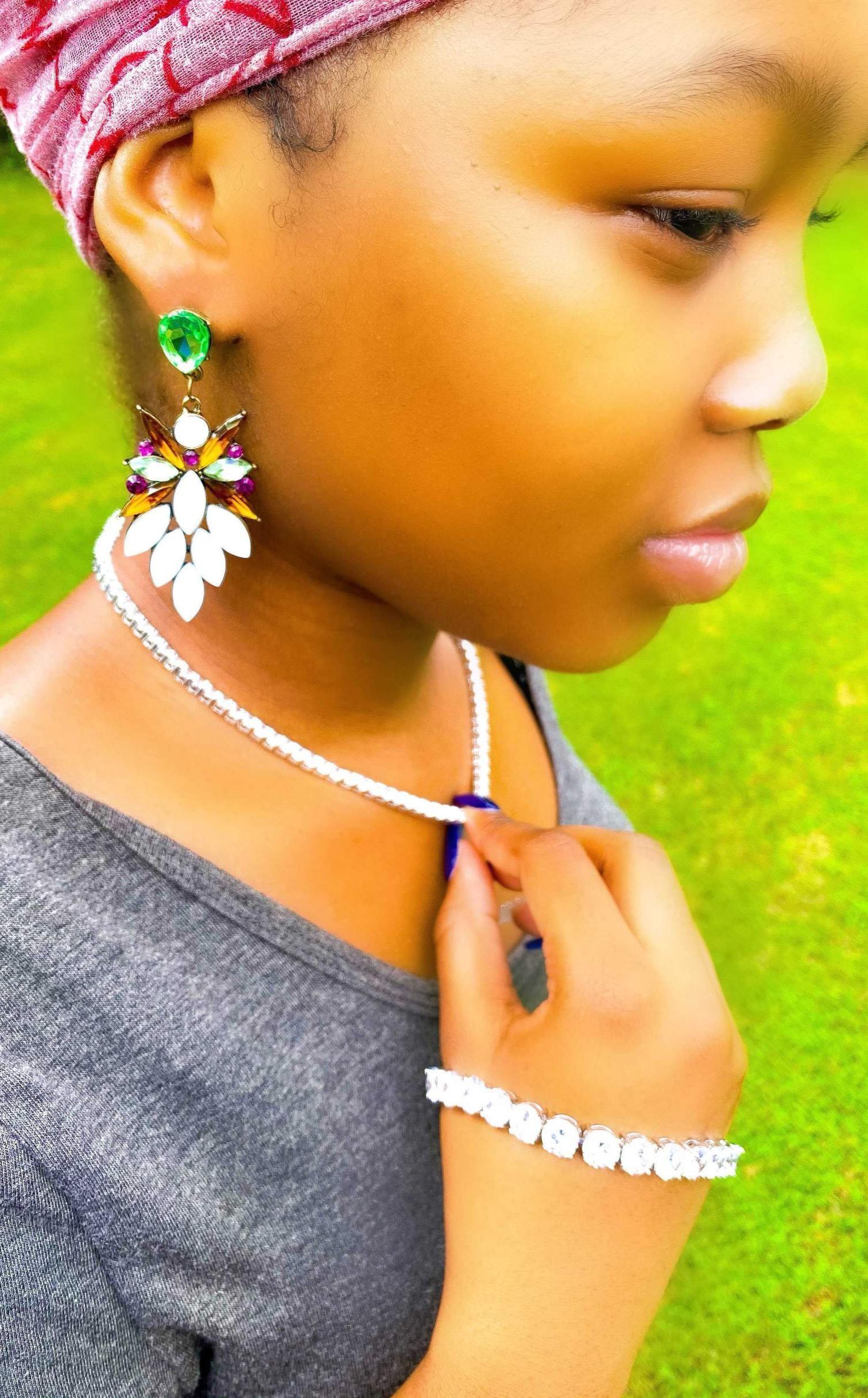 Dangle - Royale Earrings featuring crystallized stone drops in a geometric design, available in silver, green, tan, and purple.