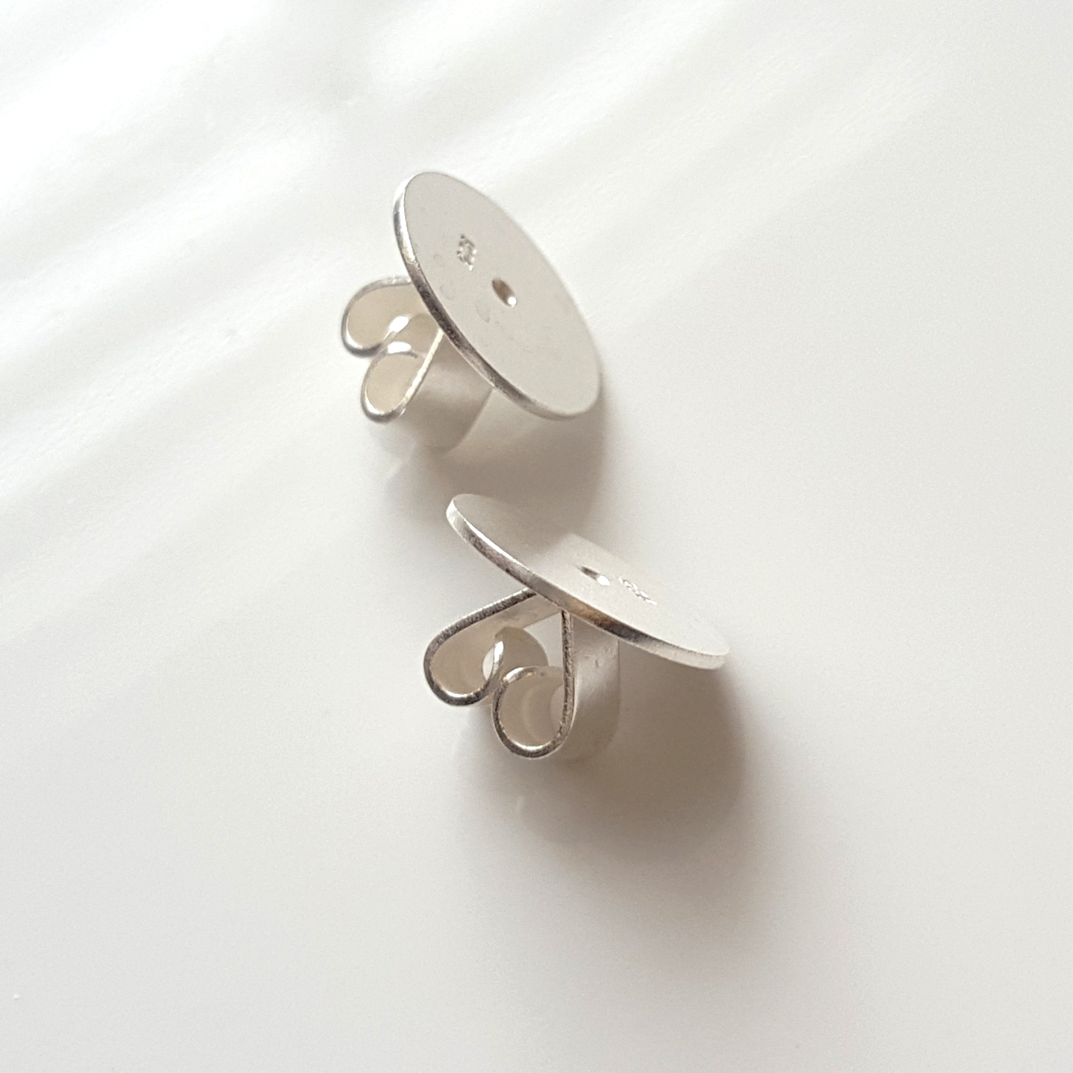 A pair of 10 mm Disc Butterfly Backs made from Sterling Silver 925, designed for secure earring support.