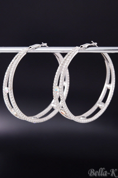 Elegant double crystal hoop earrings with a lever back closure, showcasing a chic design and double plated finish.